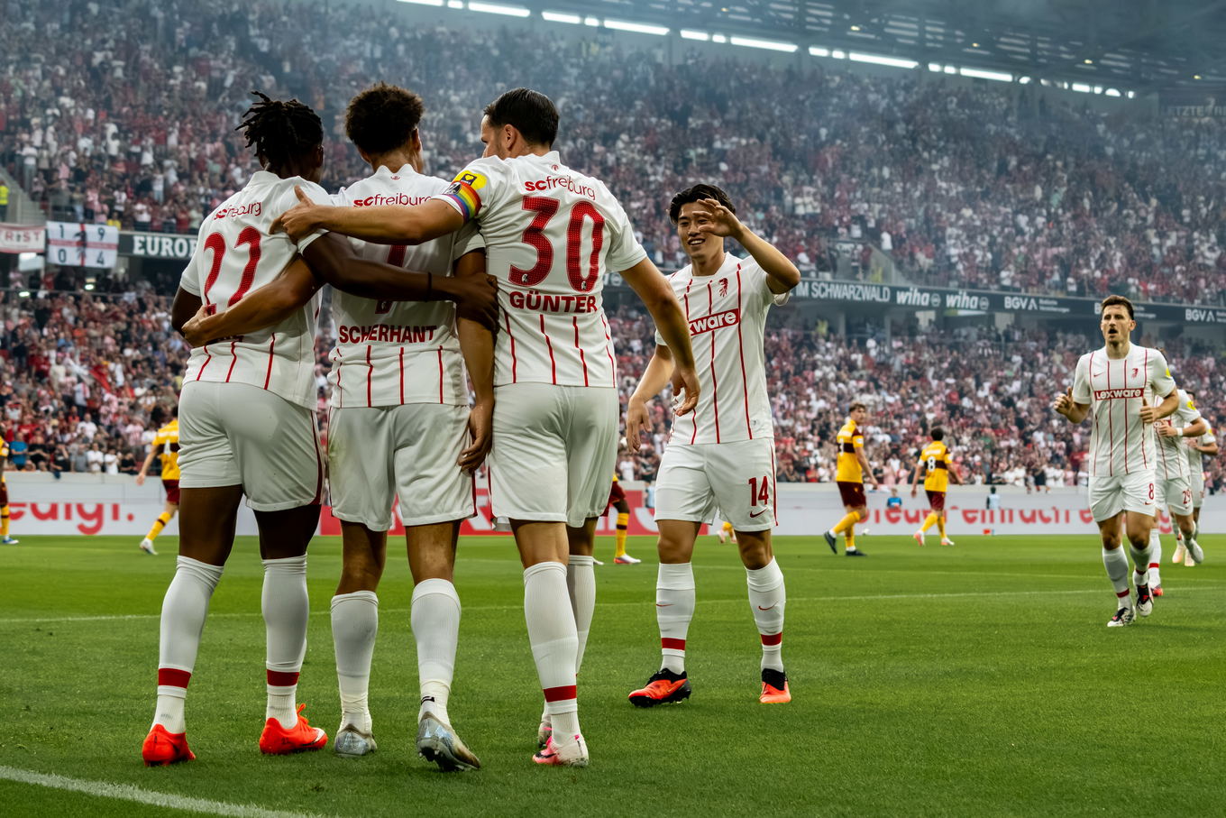 Derry Scherhant of SC Freiburg celebrates his goal with Christian Günter and Cyriaque Irie during the UEFA Conference League play-off second leg against Motherwell at the Europa-Park Stadion