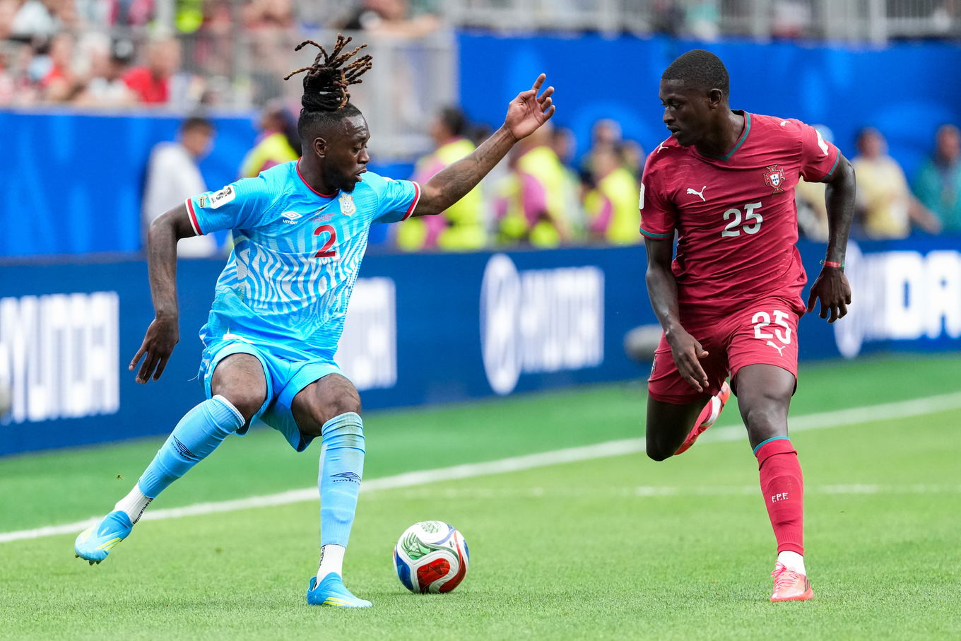 Aaron Wan-Bissaka of DR Congo runs with the ball under pressure from Portugal's Nuno Mendes during the FIFA World Cup 2026 Group K match in Houston