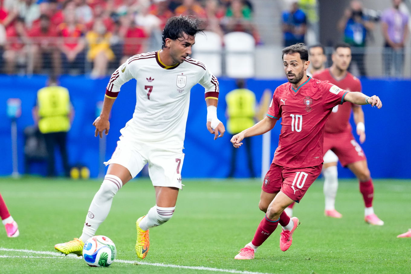 Ferran Torres of Spain runs with the ball under pressure from Portugal's Bernardo Silva during the FIFA World Cup 2026 round of 16 match at AT&T Stadium in Arlington